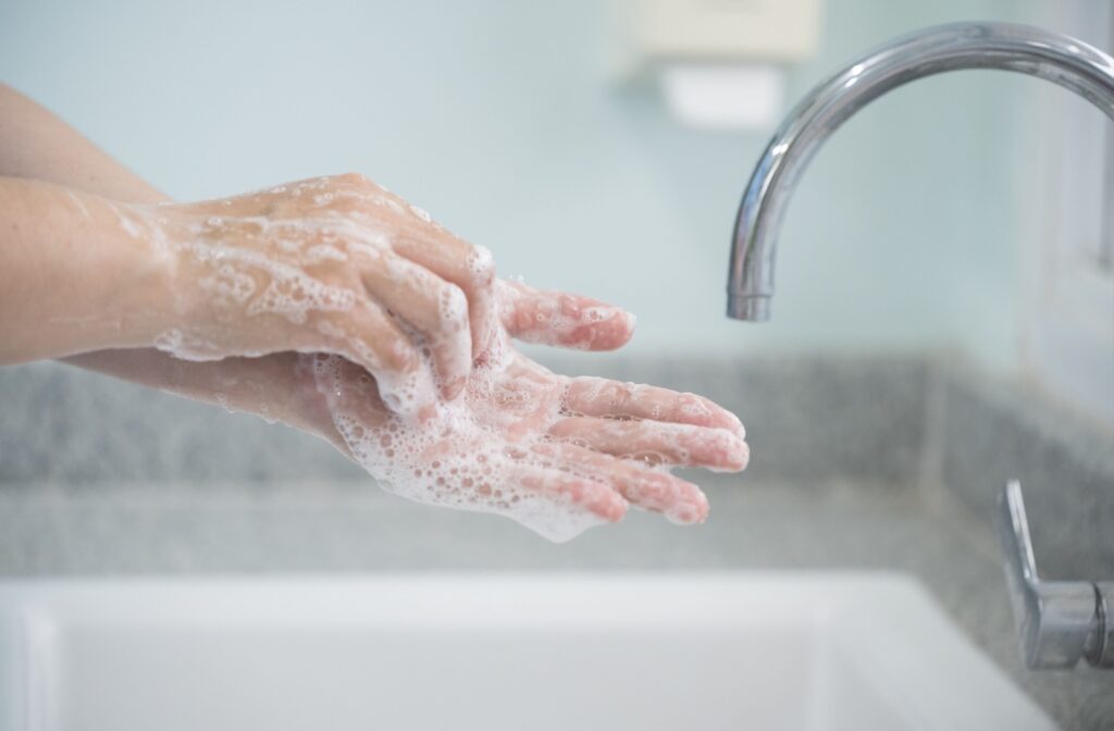 Handwashing with soap in a sink.