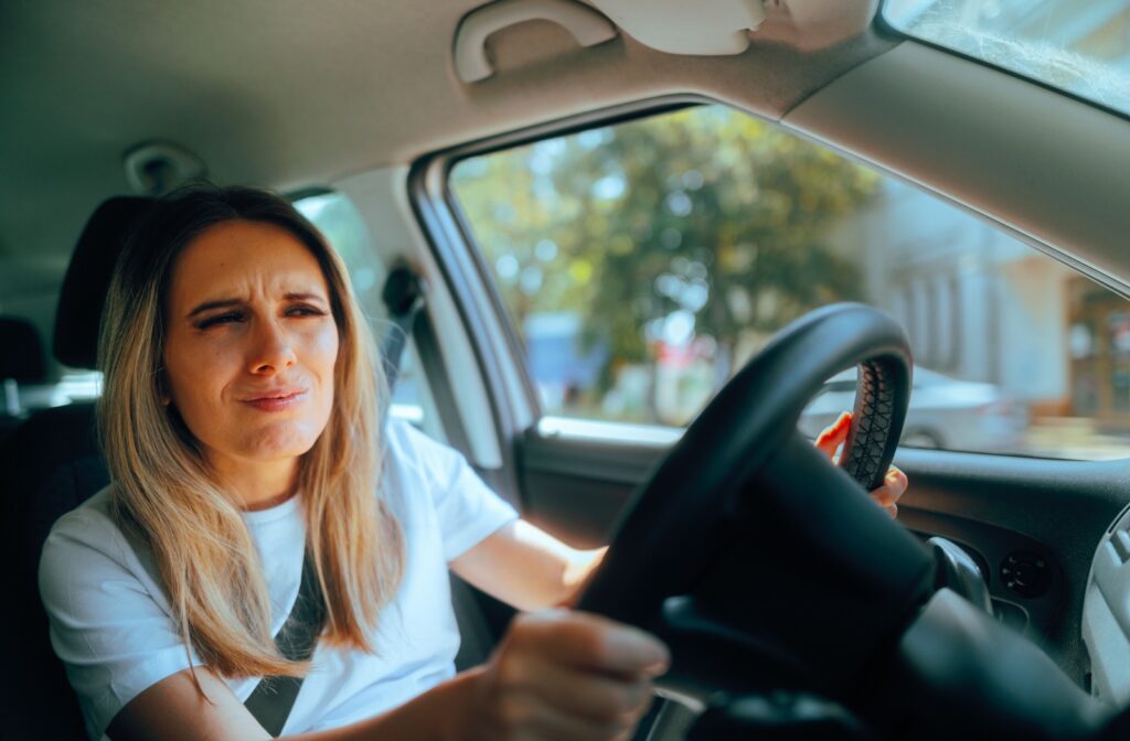 Person squinting into the distance while driving.