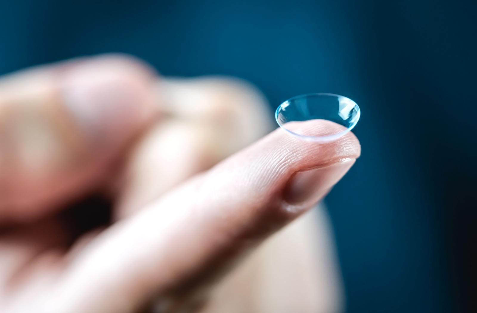 a contact lens resting on a persons finger